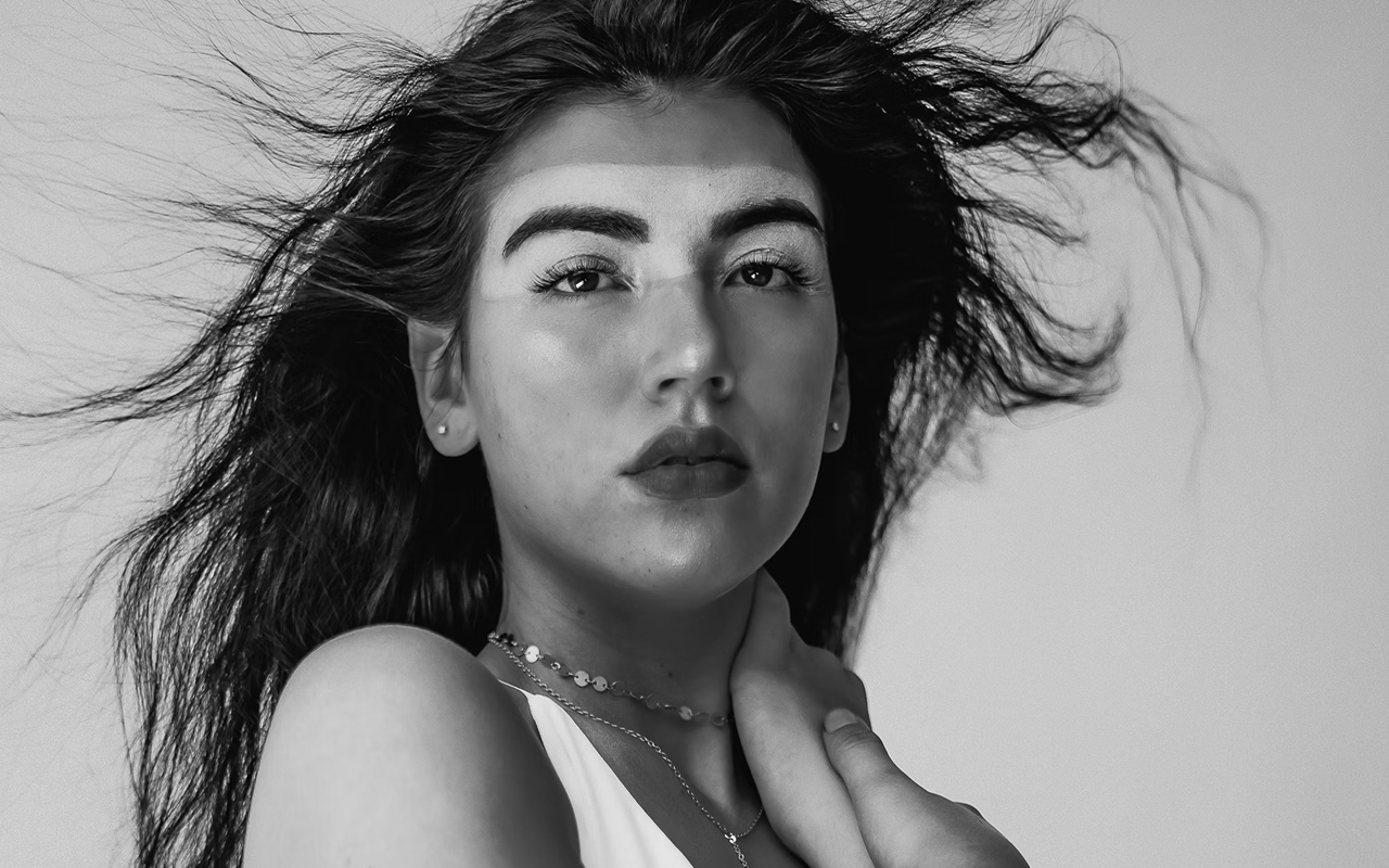 Black and white portrait of a dance instructor against a light background.
